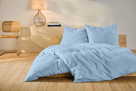 Ensemble de literie en lin bleu clair de taille standard sur un lit.