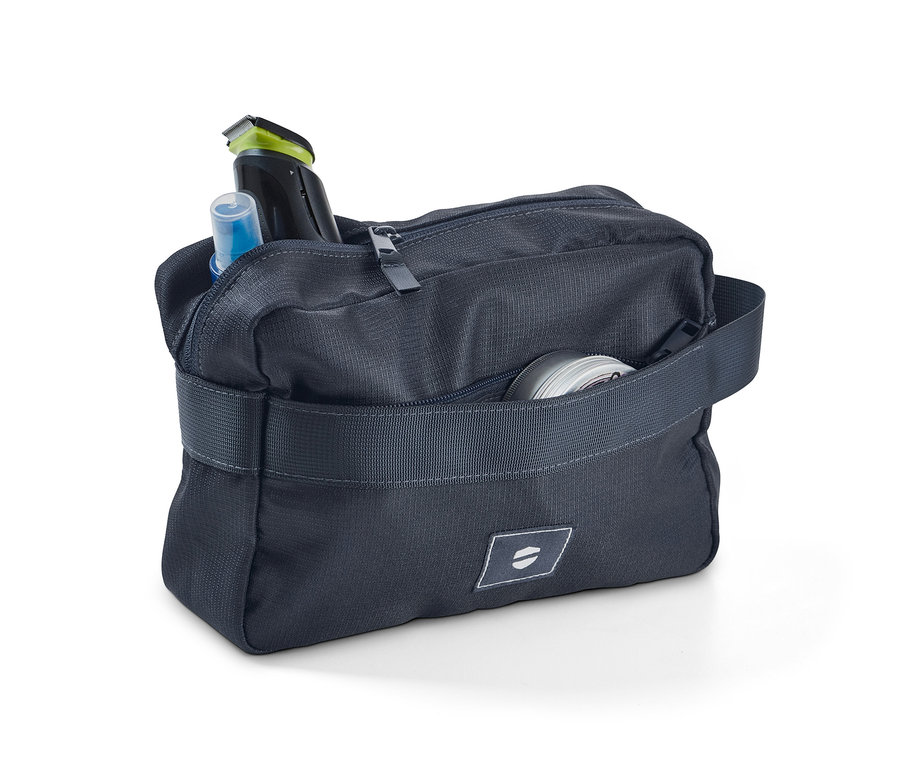 Trousse de toilette ouverte avec articles de toilette rangés.