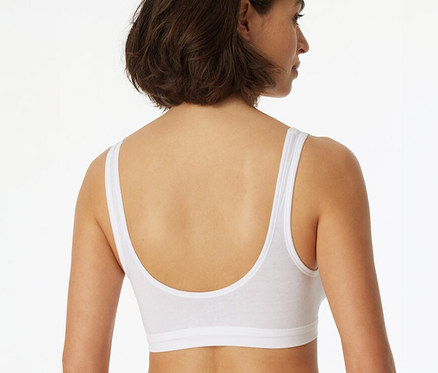Femme de dos, portant une brassière SCHIESSER blanche à bonnets.