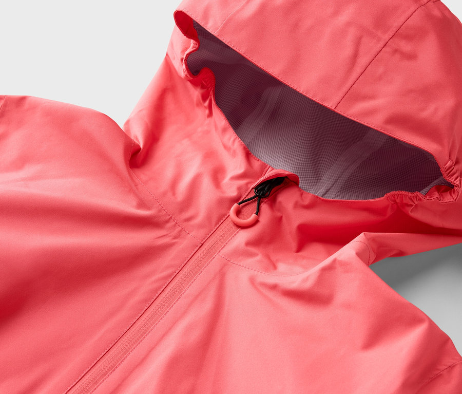 Détail d'une veste outdoor 2,5 couches rose avec capuche et fermeture éclair.