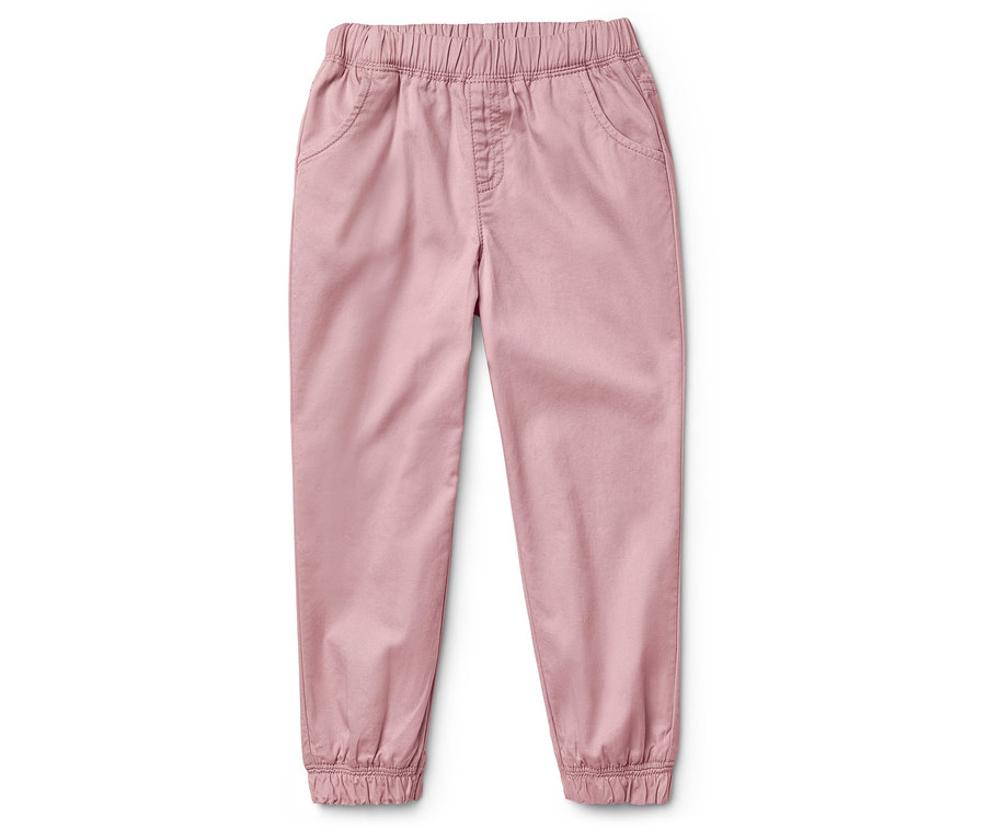 Un pantalon rose avec une taille élastique et des poignets aux chevilles, posé sur un fond blanc.