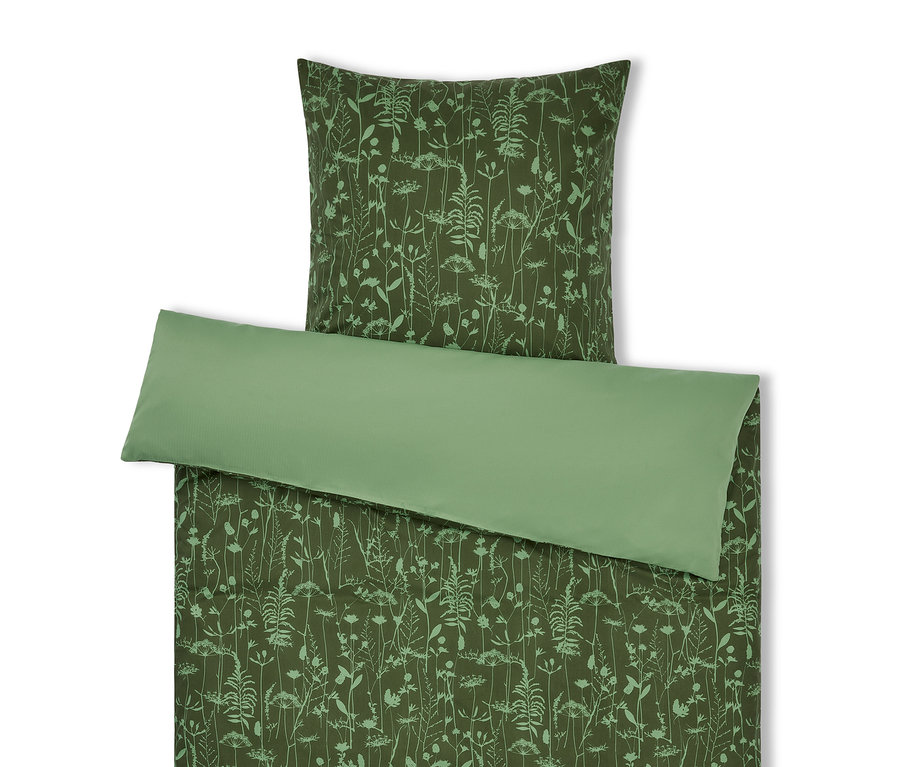 Linge de lit vert avec motif floral et oreiller vert clair.