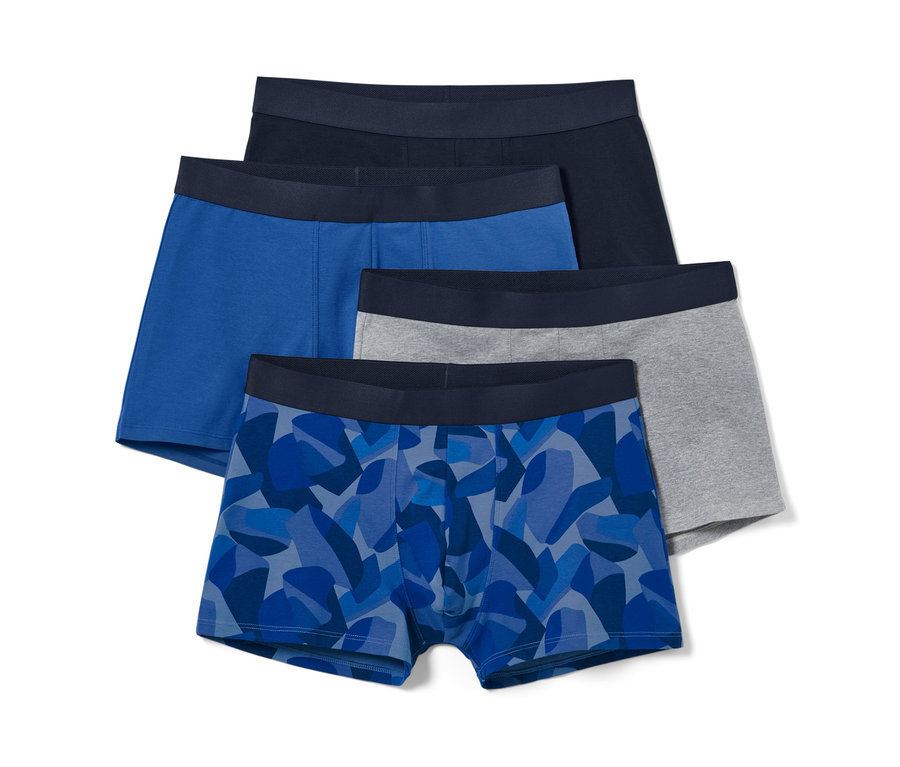 Quatre boxers : bleu avec impression intégrale, bleu, gris et bleu marine.
