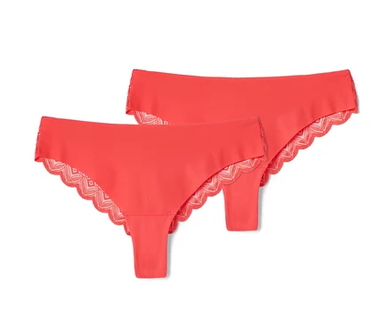 Deux tangas brésiliens Magic Cut corail posés sur un fond blanc.