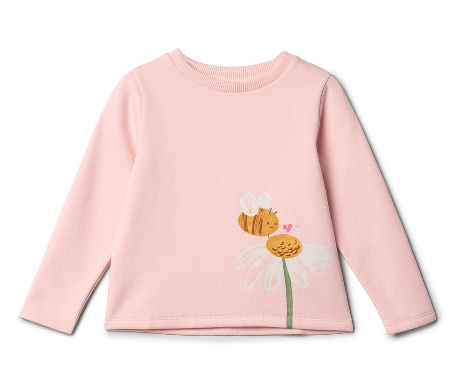 Une chemise à manches longues rose clair avec un dessin d'une abeille sur une fleur de marguerite.