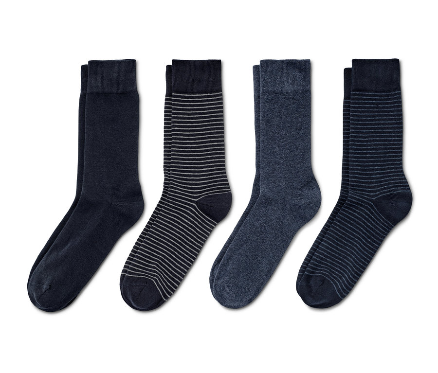 Quatre paires de chaussettes de différentes couleurs et motifs.