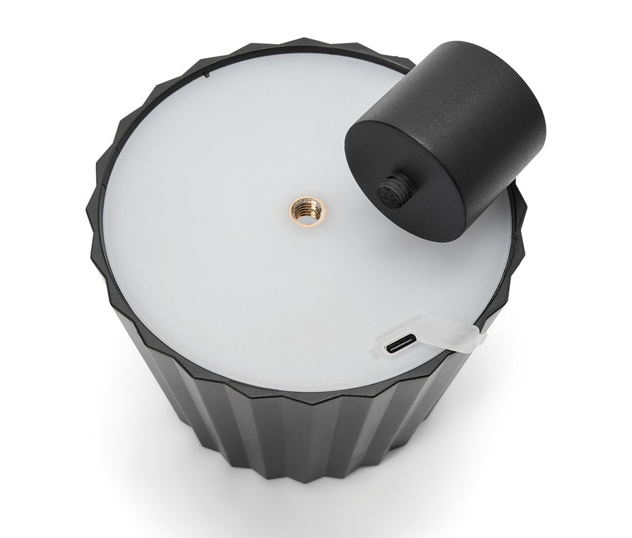 Lampe noire avec support cylindrique amovible et port USB.