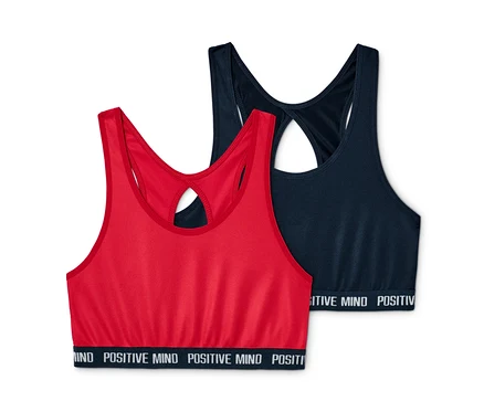 Deux brassières de sport, une rouge et une bleu foncé, sont posées l'une à côté de l'autre.