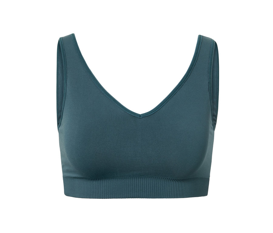 Brassière de sport sans coutures verte sur fond blanc.