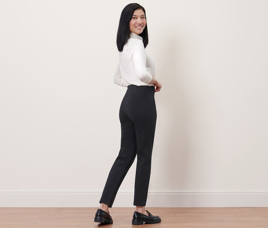 Femme posant en pantalon stretch noir.