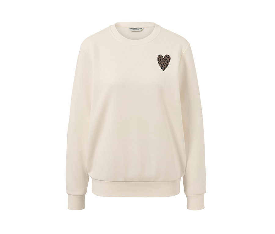 Un sweat-shirt crème avec un imprimé.
