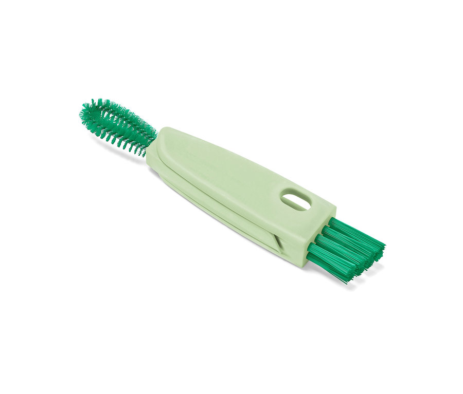 Une brosse multifonction 3 en 1 verte sur fond blanc.