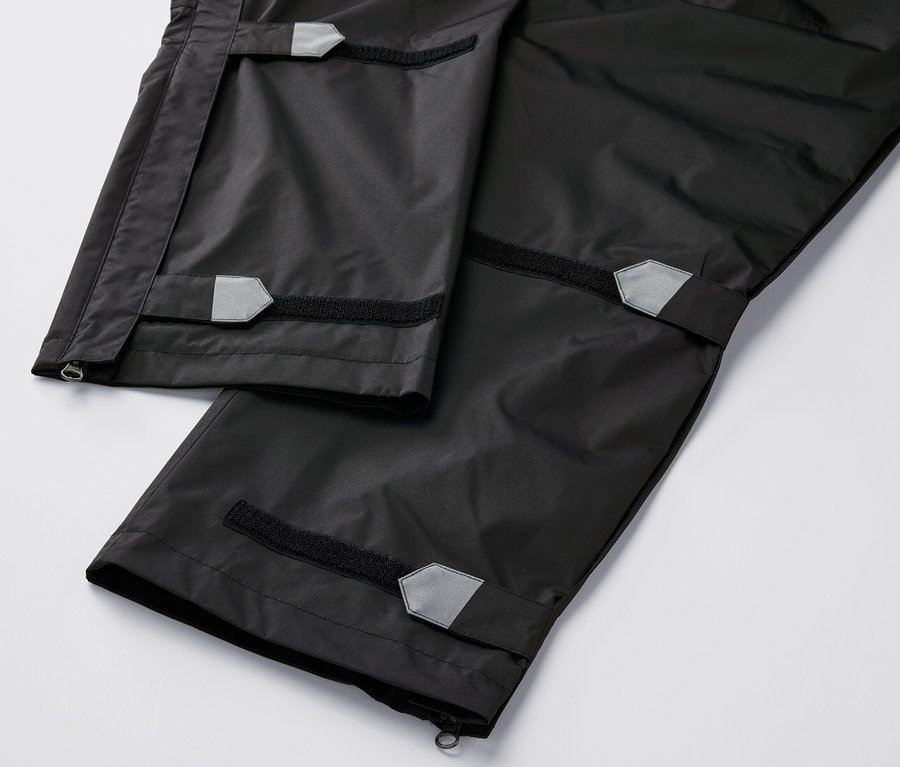 Gros plan sur un pantalon de pluie high-tech noir.