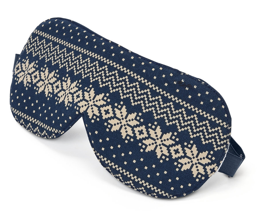 Masque de sommeil bleu avec motif de flocons de neige sur fond blanc.