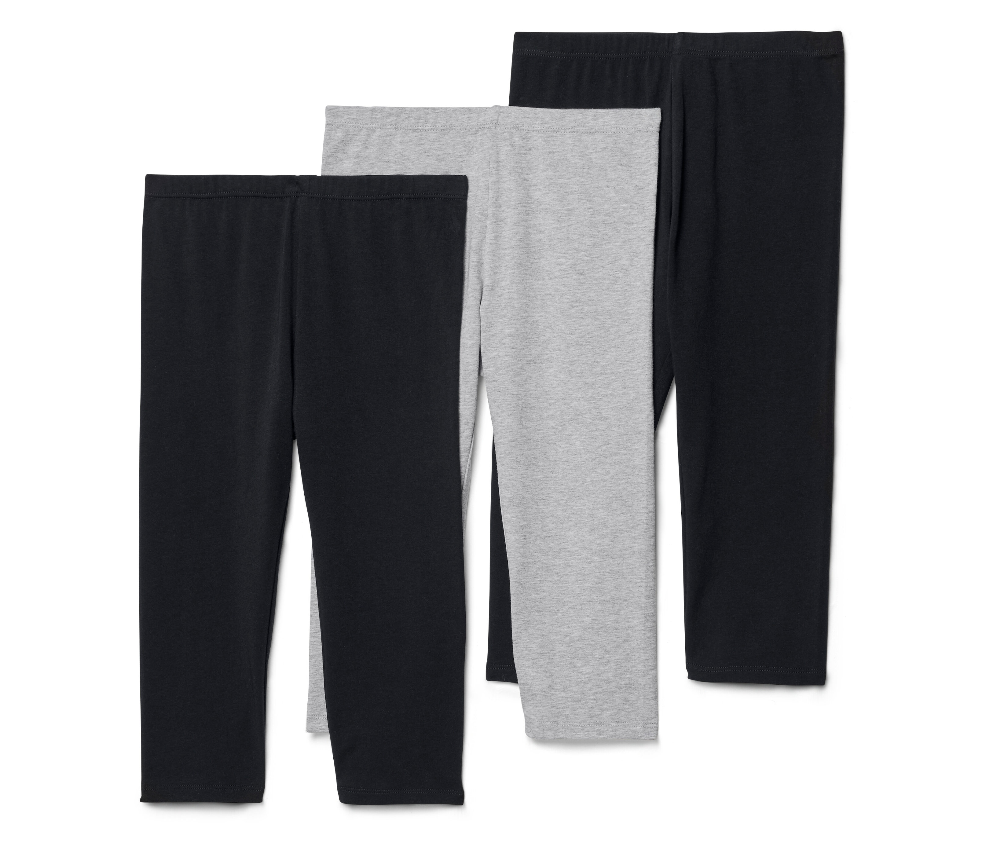 Trois leggings, deux noirs et un gris, sont disposés côte à côte.