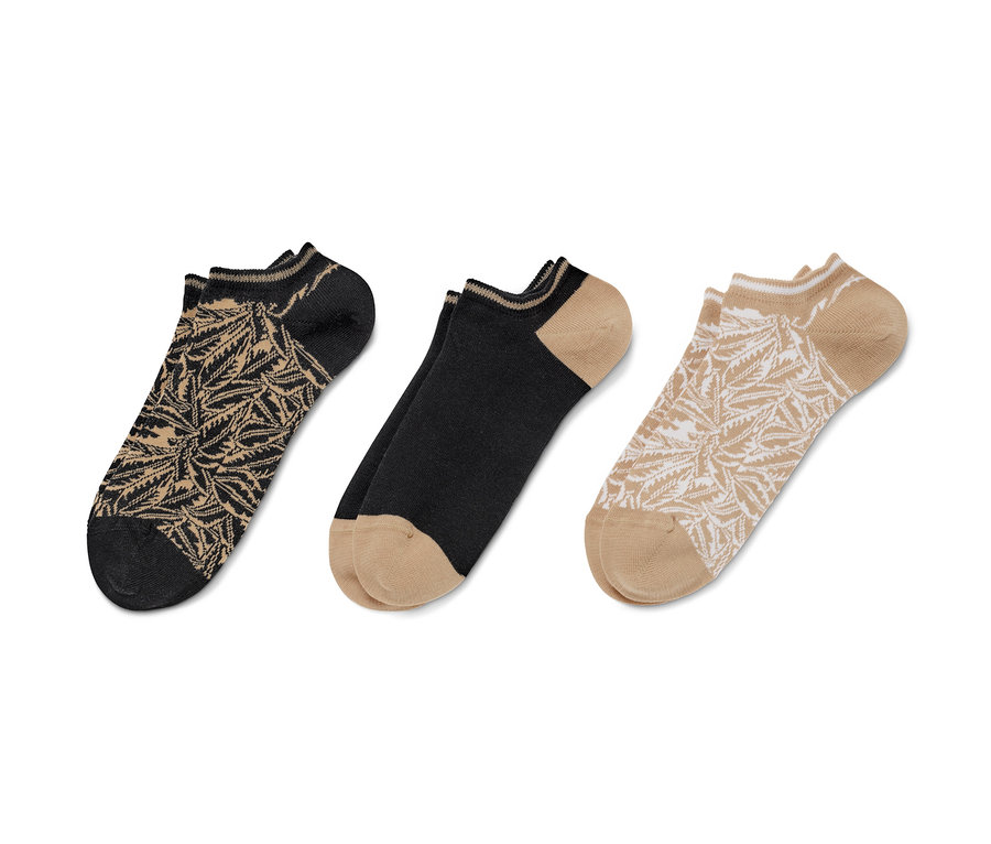 Trois paires de socquettes de sport avec des feuilles de palmier.