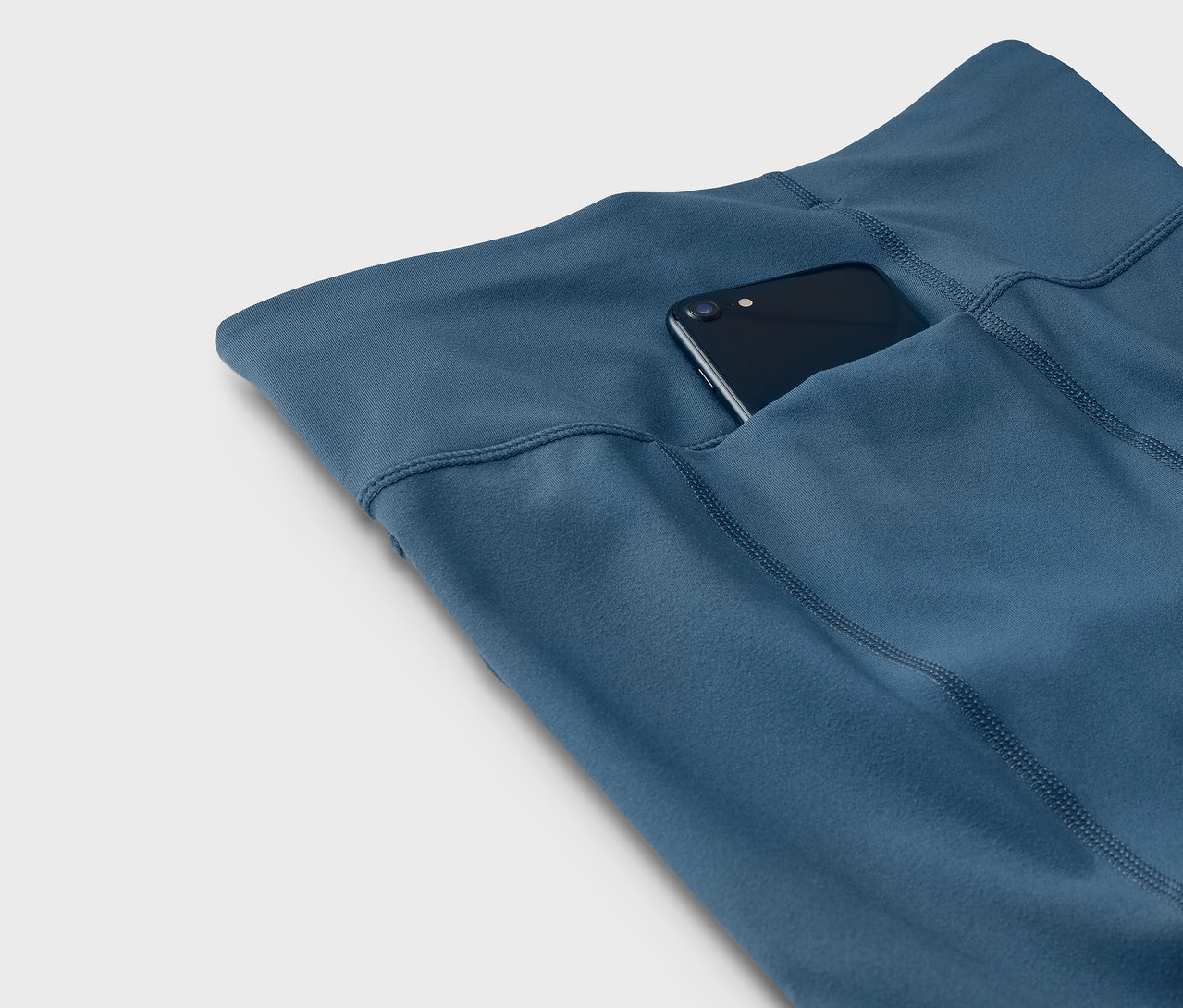 Leggings bleus avec un téléphone dans la poche.