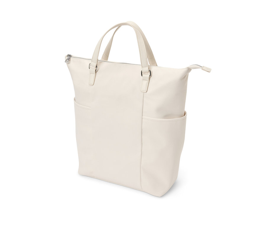 Un sac à dos en toile couleur crème avec deux poignées et une poche extérieure.