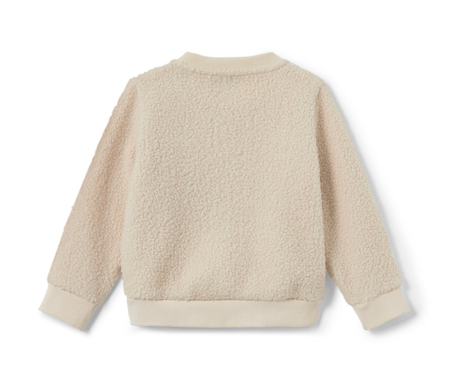 Gros plan sur un sweatshirt nounours pour enfant.
