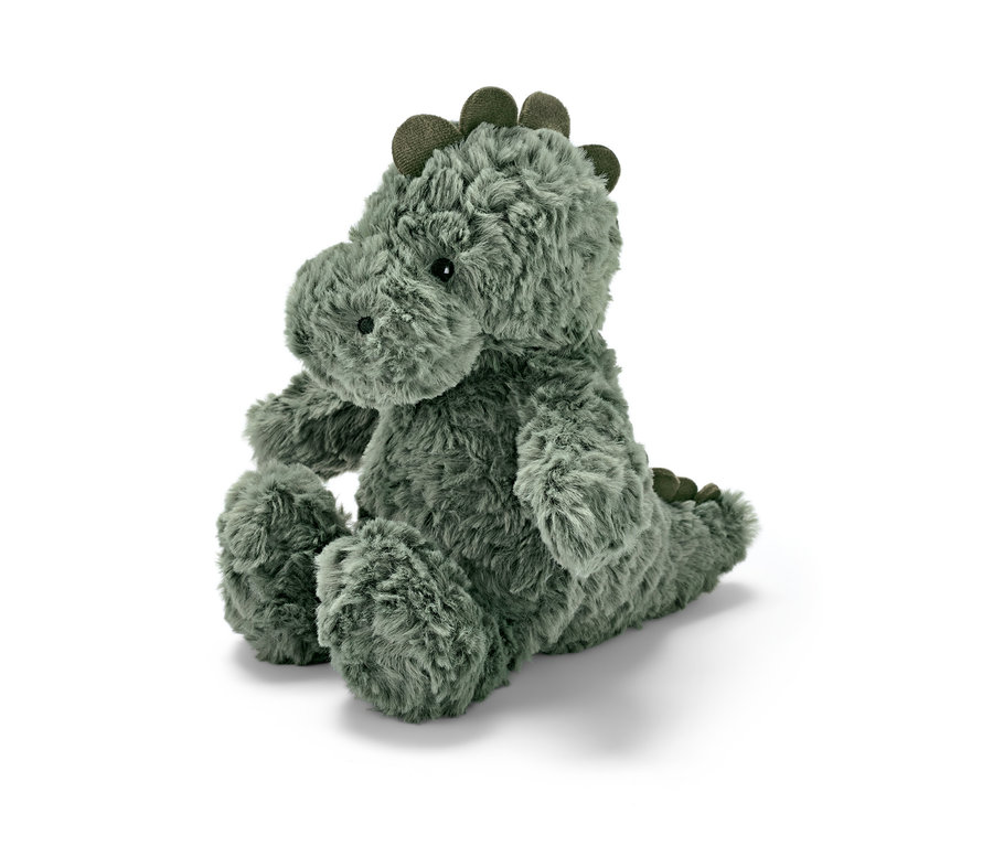 Une peluche « Dinosaure » est assise sur un fond blanc.