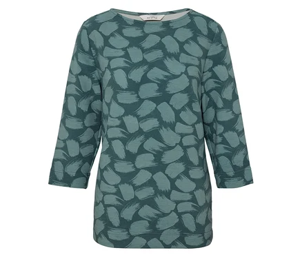 Un haut pour femme avec des manches trois-quarts et un motif vert.