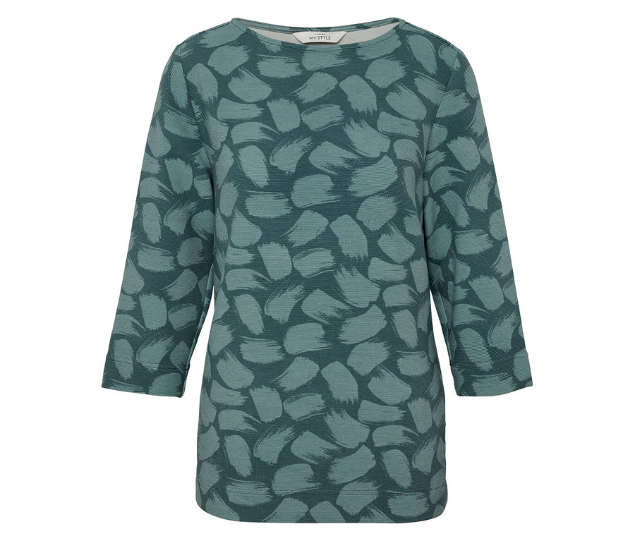 Un haut pour femme avec des manches trois-quarts et un motif vert.