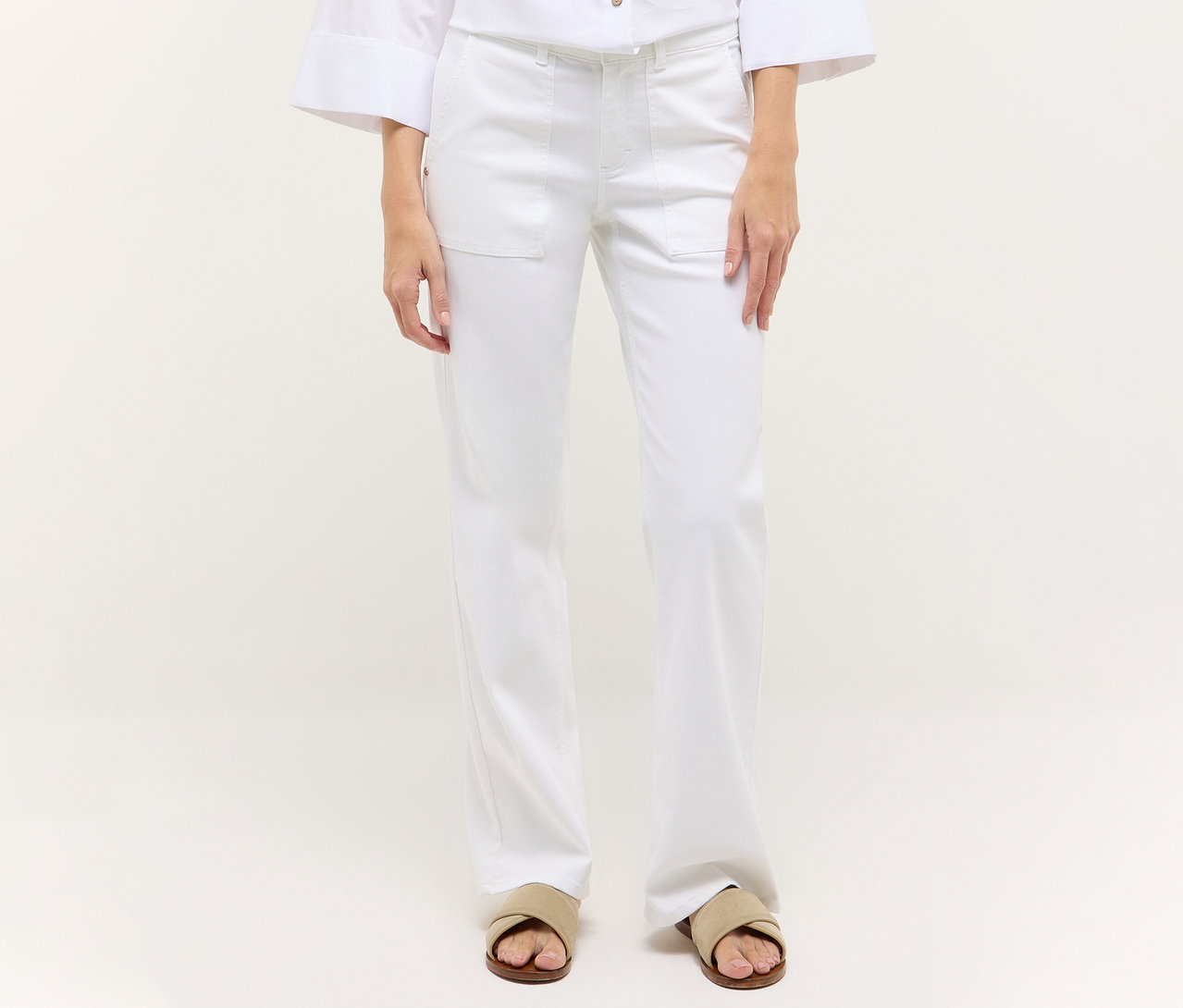 Une personne porte un jean blanc Angels Denim «Liz Urban» Wide Leg et des sandales.