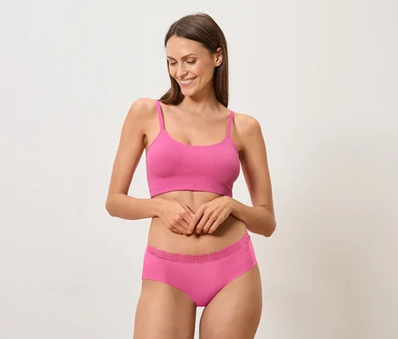 Femme portant une brassière et des sous-vêtements roses.