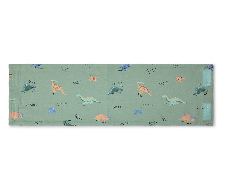 Housse à langer verte avec motif de dinosaures.
