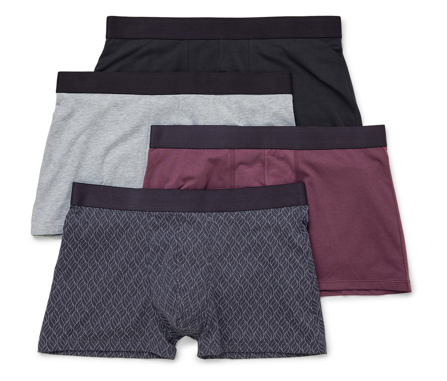 Quatre boxers pour hommes en noir, gris, bordeaux et à motif de feuilles sont superposés.