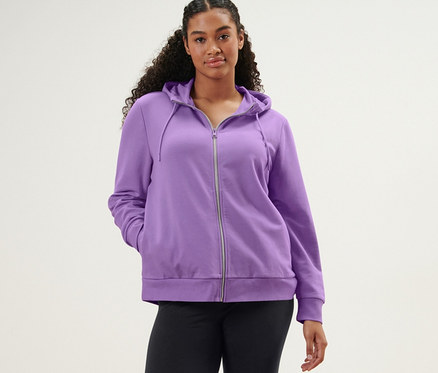 Femme posant en legging de sport et veste molletonnée lavande.