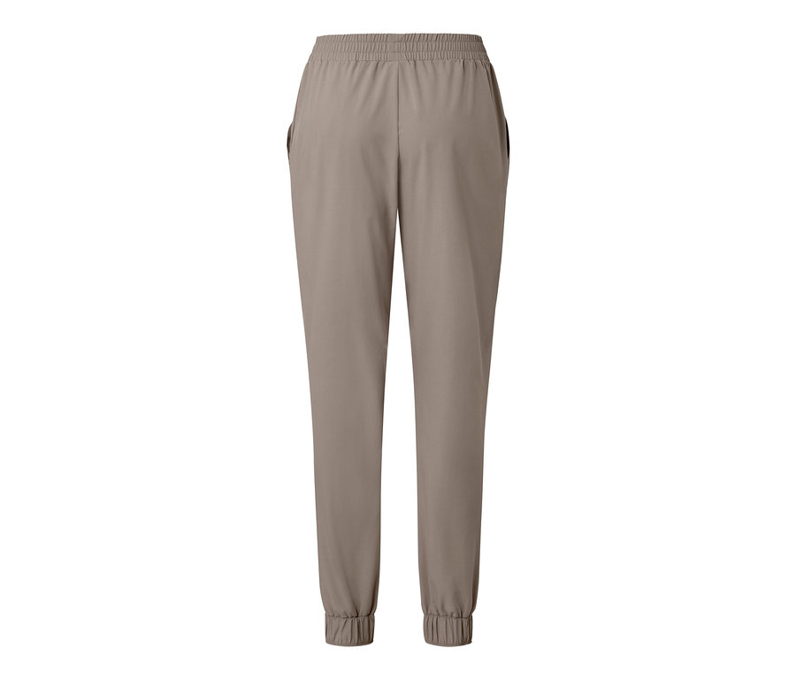 Pantalon fonctionnel beige avec taille élastique et poignets.