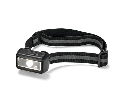 Gros plan d'une lampe frontale compacte avec un bandeau noir et une lumière allumée.