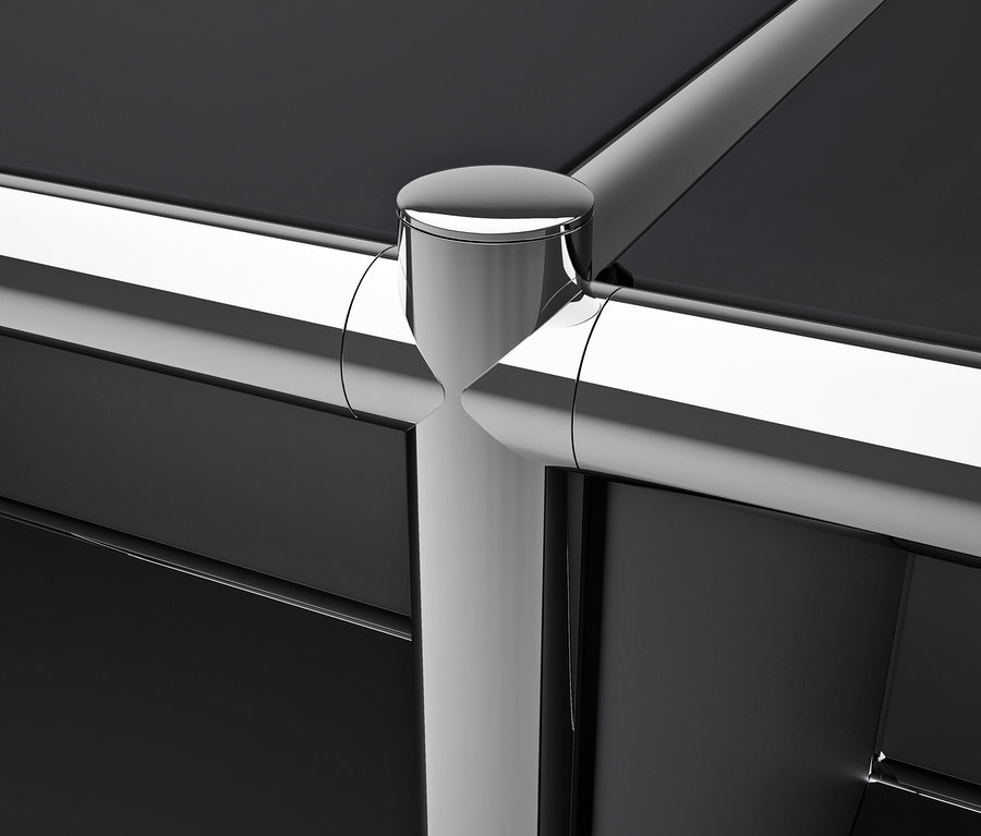 Détail d'un meuble en métal noir CN3 avec des tubes chromés.