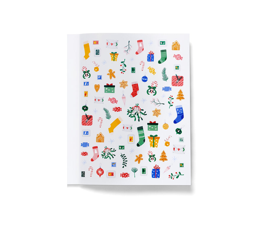 Livre ouvert avec autocollants de Noël.