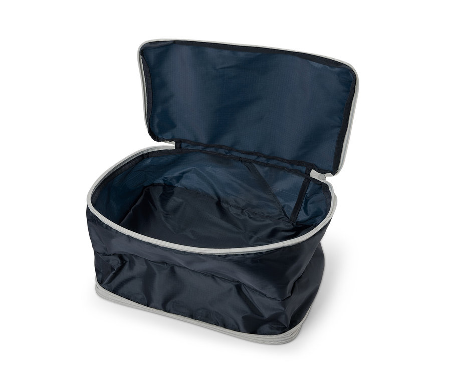 Sac de compression ouvert bleu foncé avec fermeture éclair grise.