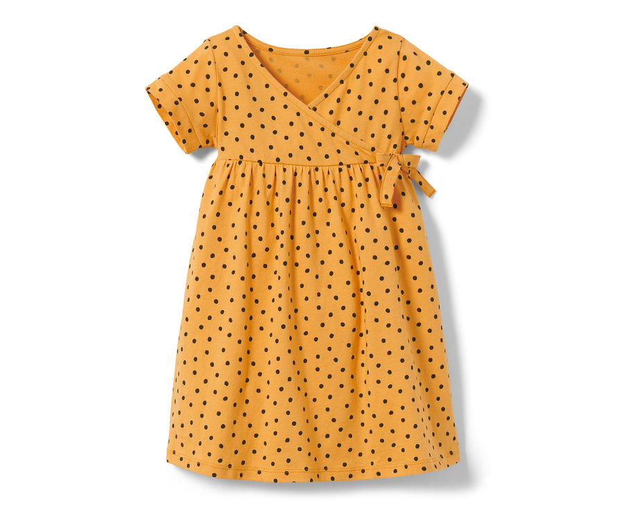 Robe en jersey jaune pour enfant avec des pois noirs.