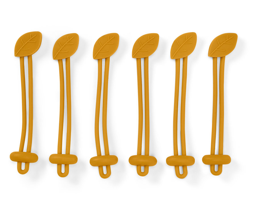 Six attaches en silicone jaune avec un motif de feuille sur le dessus et une fermeture en forme de U en bas sur un fond blanc.