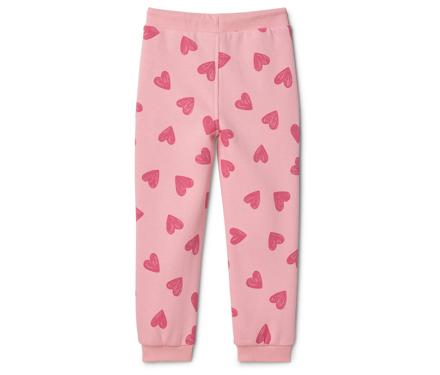 Pantalon rose pour enfant avec motif de coeurs.