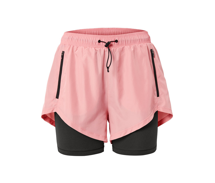 Short de sport 2 en 1 rose avec fermetures éclair noires et cordon de serrage.