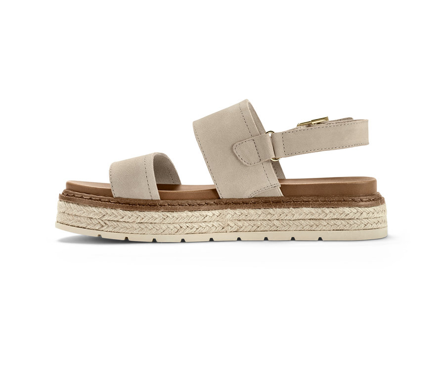 Sandale à plateau en cuir beige avec une semelle marron.
