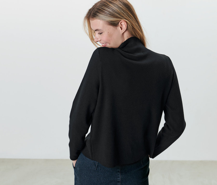 Femme portant un pull en maille noir.