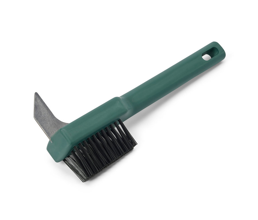 Brosse de nettoyage pour joints de jardin avec manche vert et poils noirs.