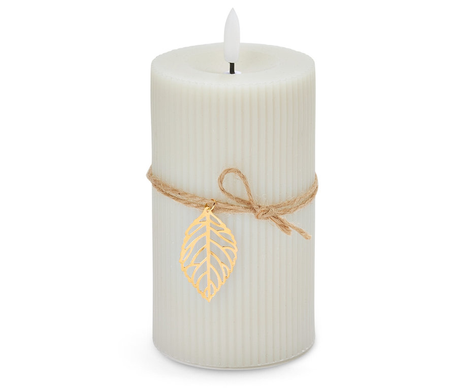 Une bougie blanche avec une ficelle et une feuille d'or sur fond blanc.