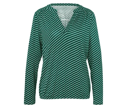 Chemisier à manches longues vert à pois blancs pour femme.