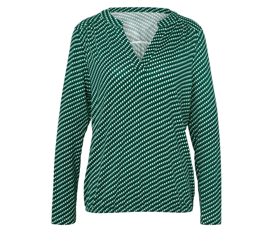 Chemisier à manches longues vert à pois blancs pour femme.