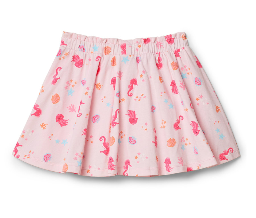 Une jupe rose avec des motifs d'hippocampes, de méduses, de coquillages et d'étoiles.