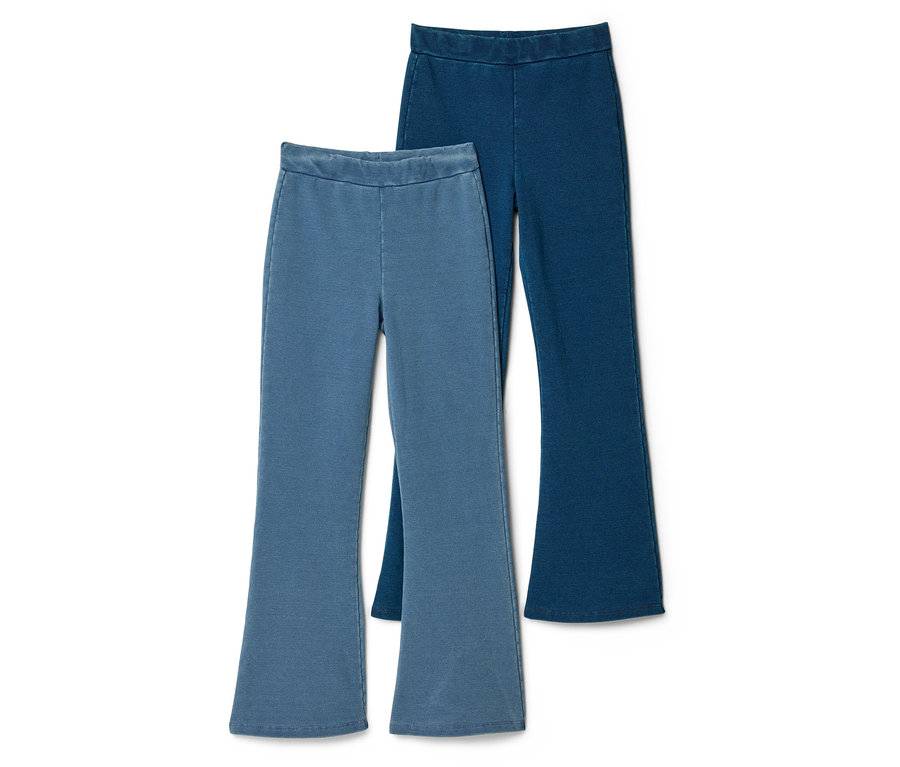Deux jeggings flared pour enfant, un bleu clair et un bleu foncé, sont posés en superposition sur un fond blanc.