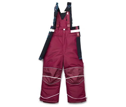 Combinaison de ski 2 pièces pour enfant: veste bleu foncé à motifs floraux et pantalon salopette bordeaux.
