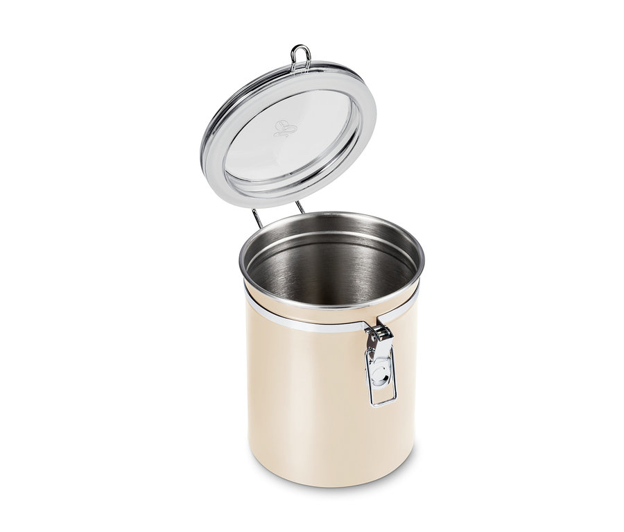 Boîte à arômes beige tendre ouverte avec couvercle et fermeture argentés.